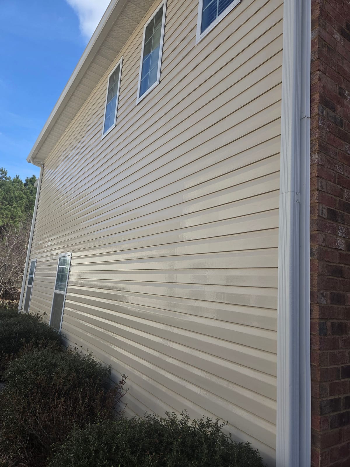 After soft washing: the same two-story vinyl-sided home in Lexington, SC, algae-free